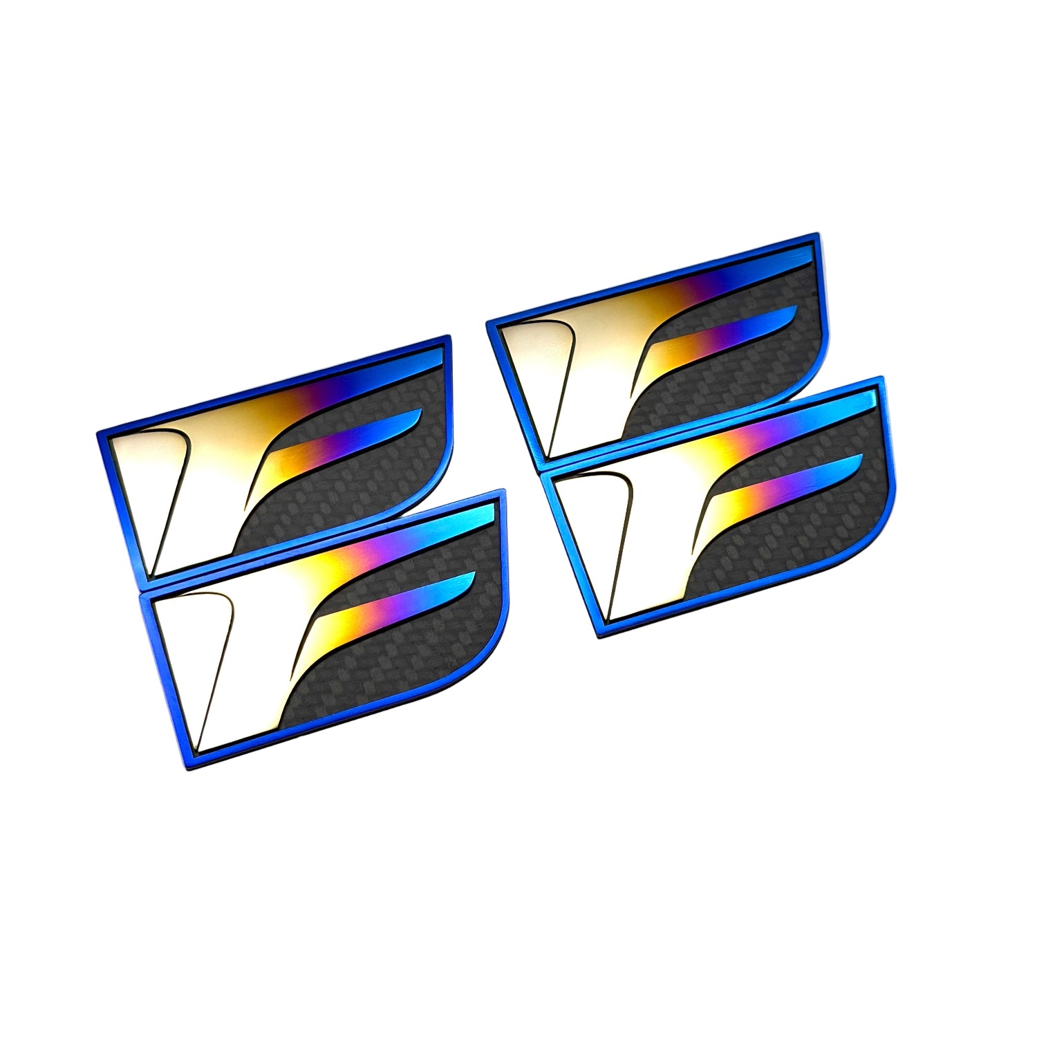 titanium and carbon fiber Lexus F badges in an anodized burnt and rainbow gradient finish.