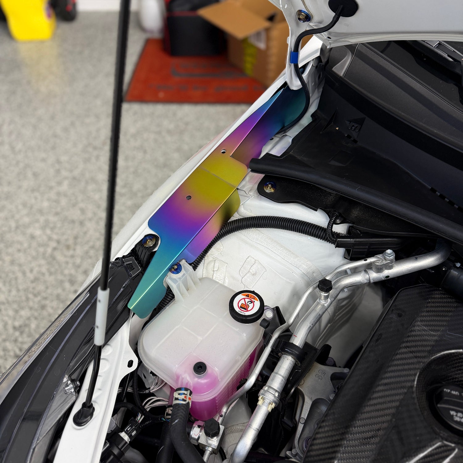 JDC Titanium fender shroud for 2023-2025 Toyota GR Corolla in a Freaktanium gradient finish installed on a white GR Corolla.