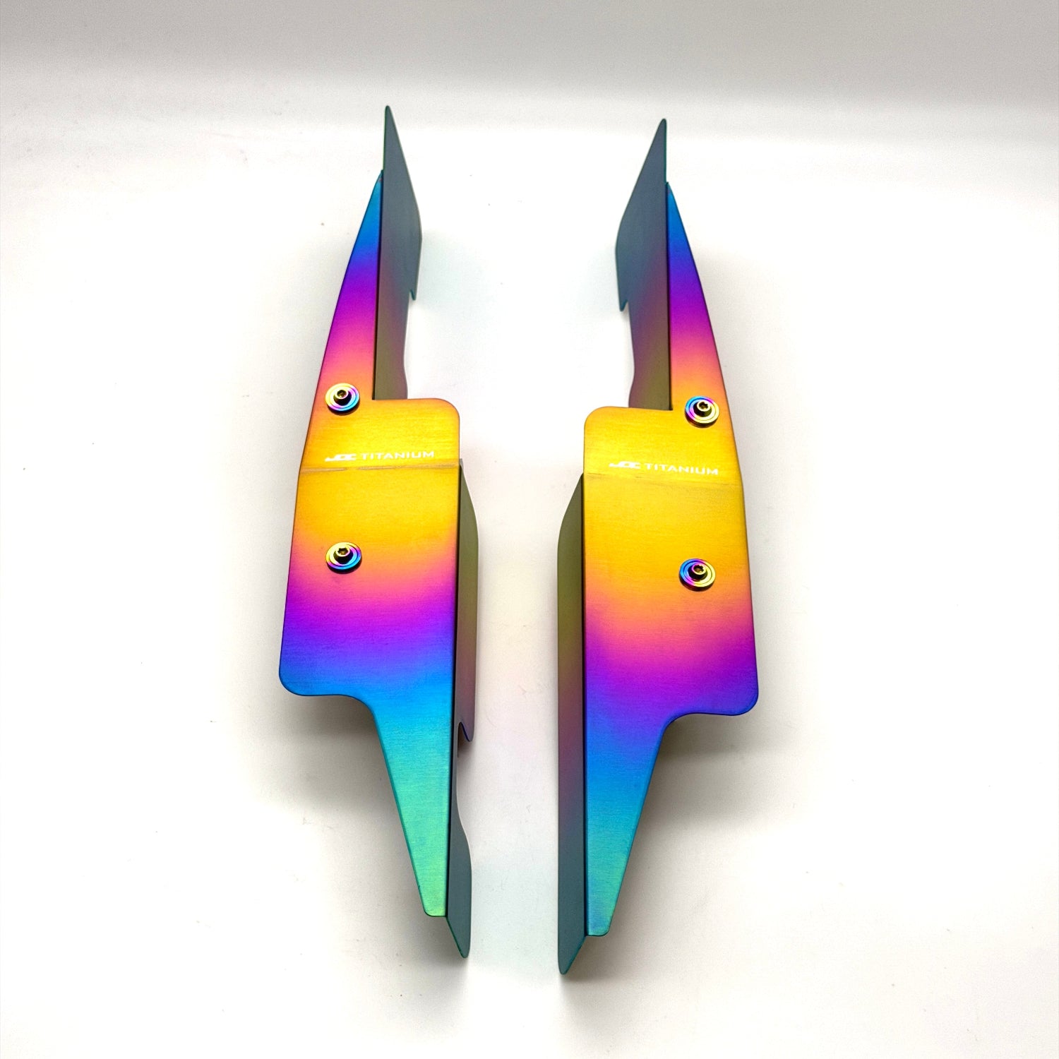 JDC Titanium fender shroud for 2023-2025 Toyota GR Corolla in a Freaktanium gradient finish with matching titanium hardware on a white background