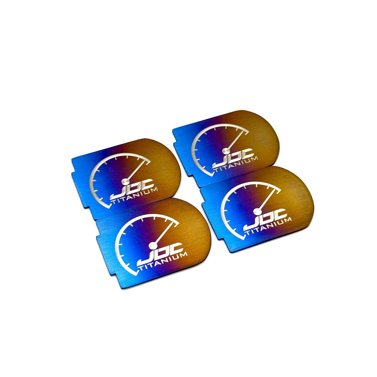 Four JDC Titanium coil plaques on a white background