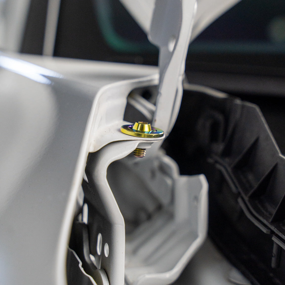 Gradient freaktanium titanium hardware installed on a white Acura Integra A-Spec