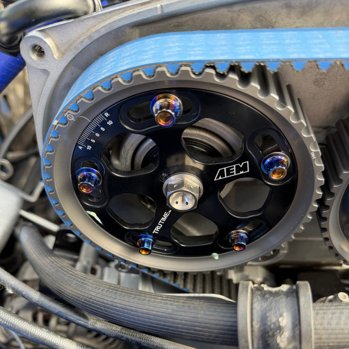 JDC Titanium hardware in a burnt gradient finish installed on an AEM Cam Gear.