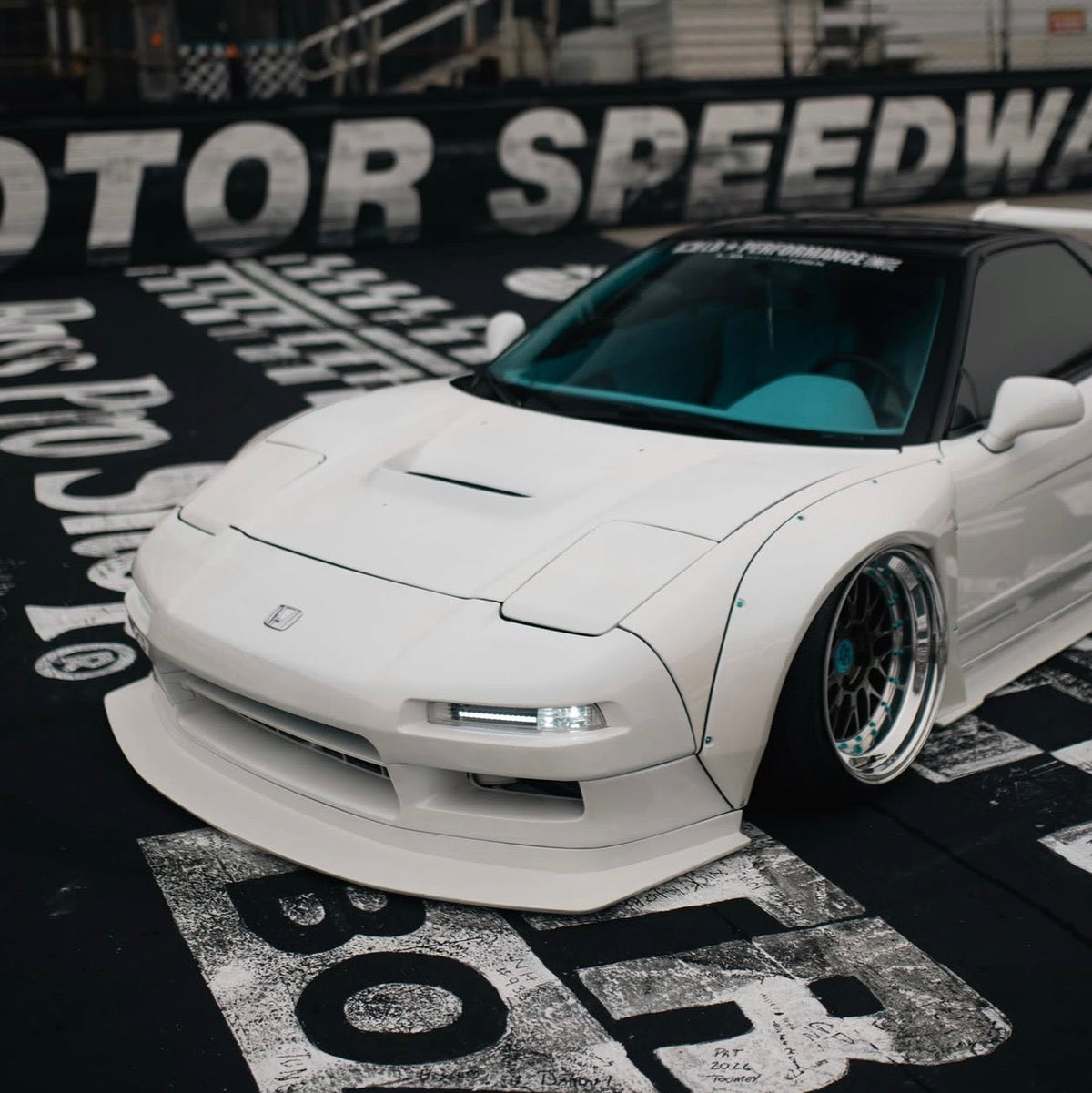 JDC Titanium wide body hardware in an anodized teal color installed on an Acura NSX