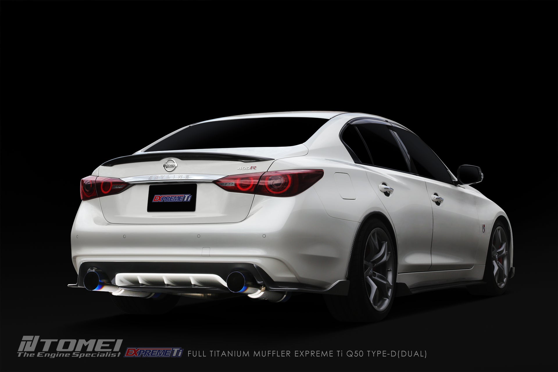 White Infiniti Q60 with a dark background and Tomei dual exhaust system.