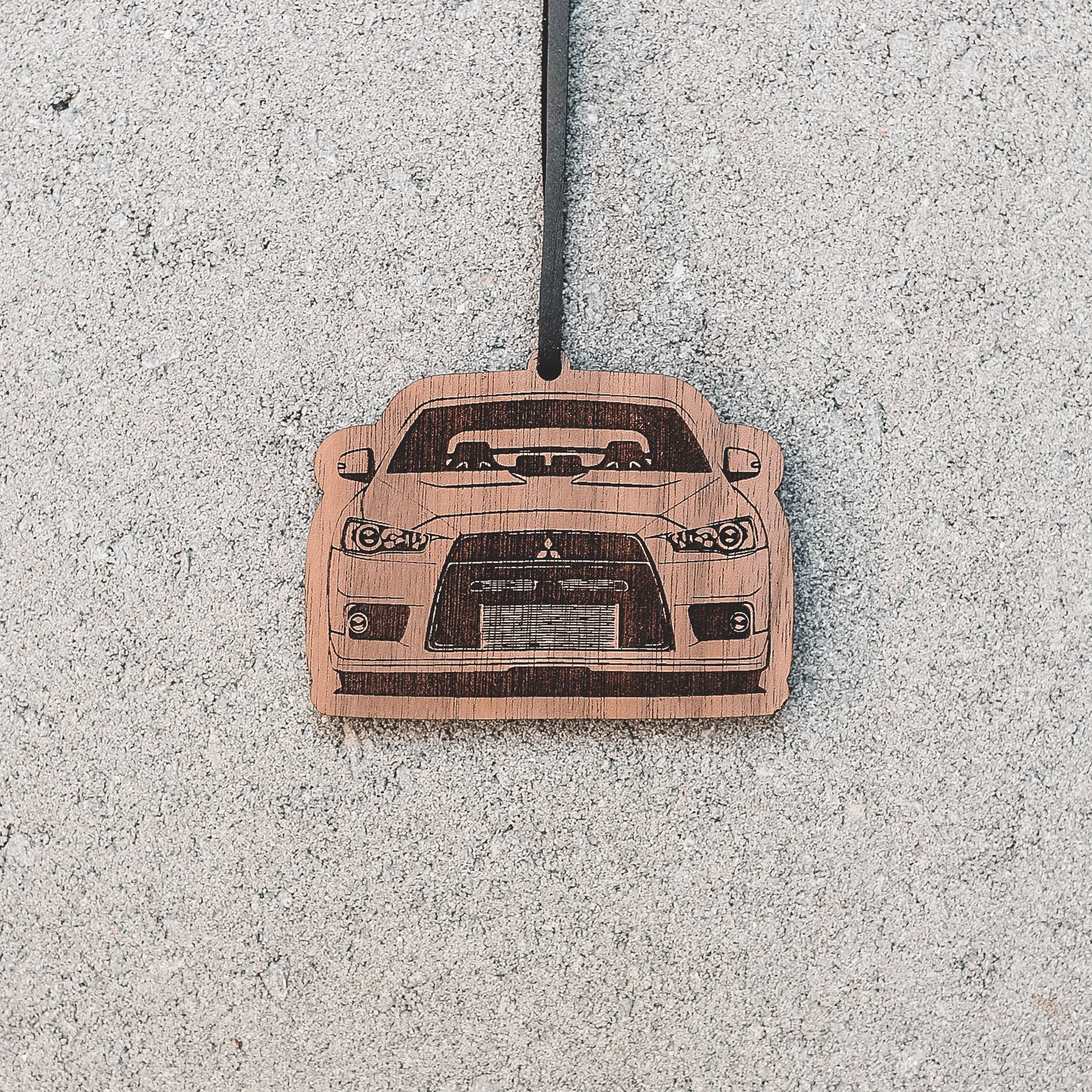 Car air freshener with a car design on a textured surface
