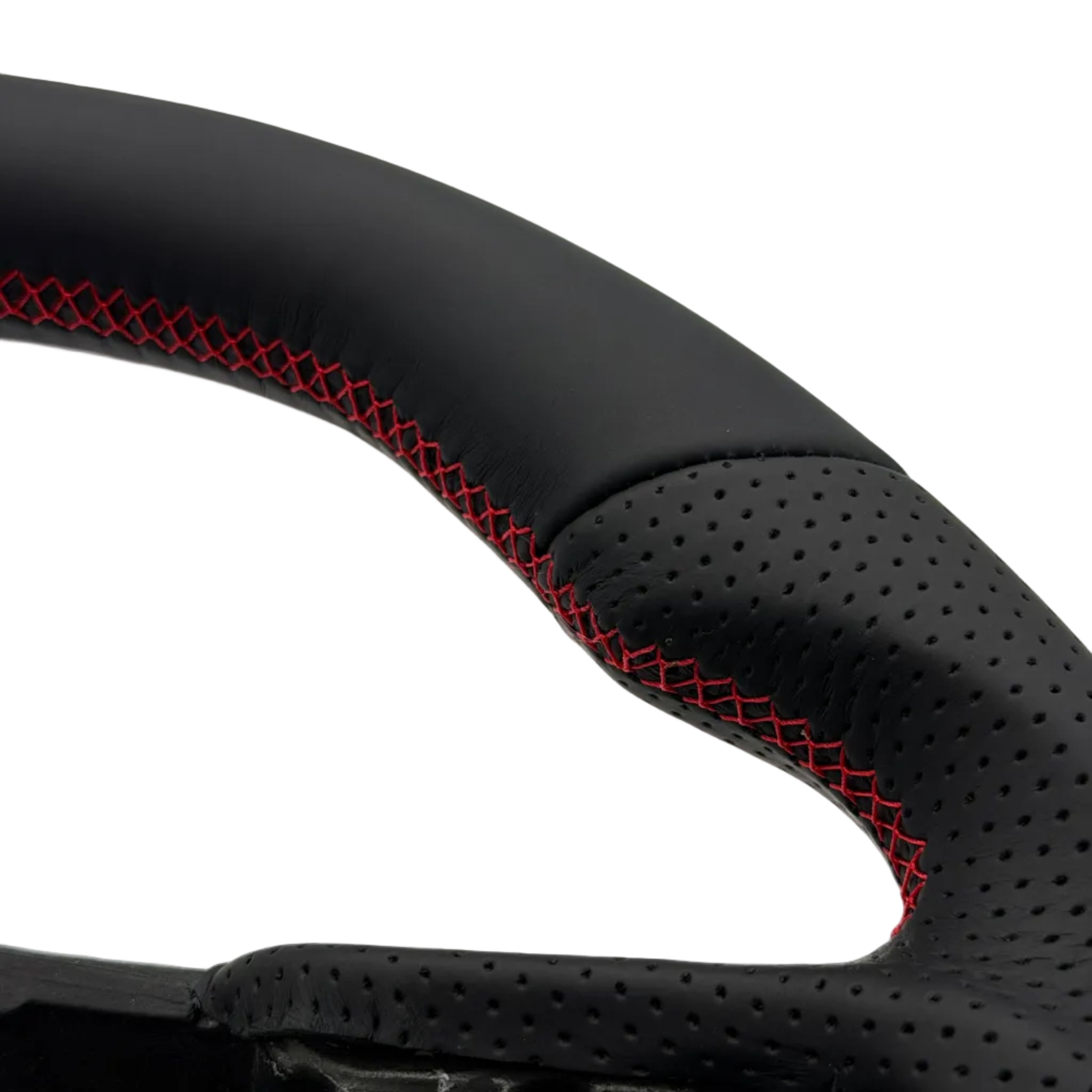 Close-up of a black perforated leather steering wheel rim with red contrast stitching, showing the textured grip and inner structure against a white background.