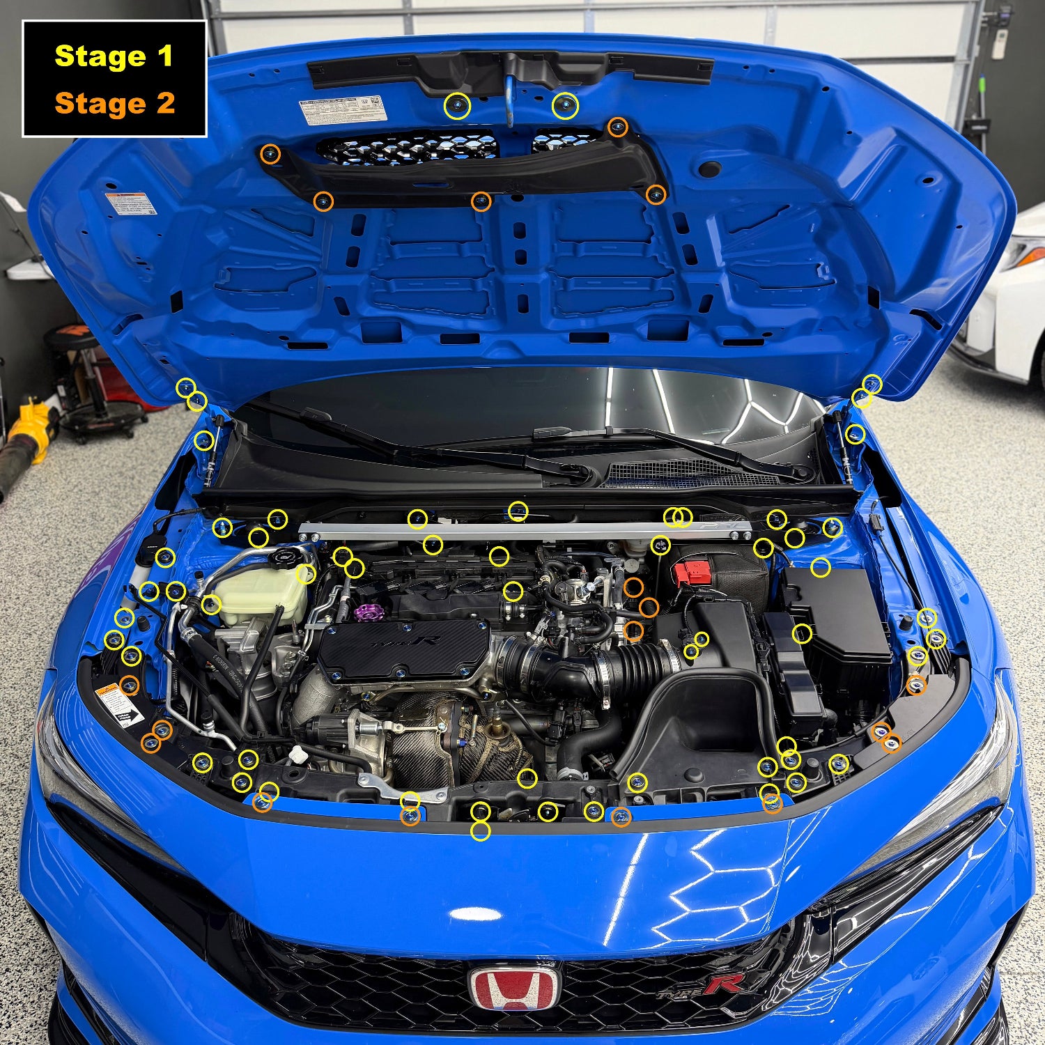 Blue car with open hood showing engine compartment and labeled parts.