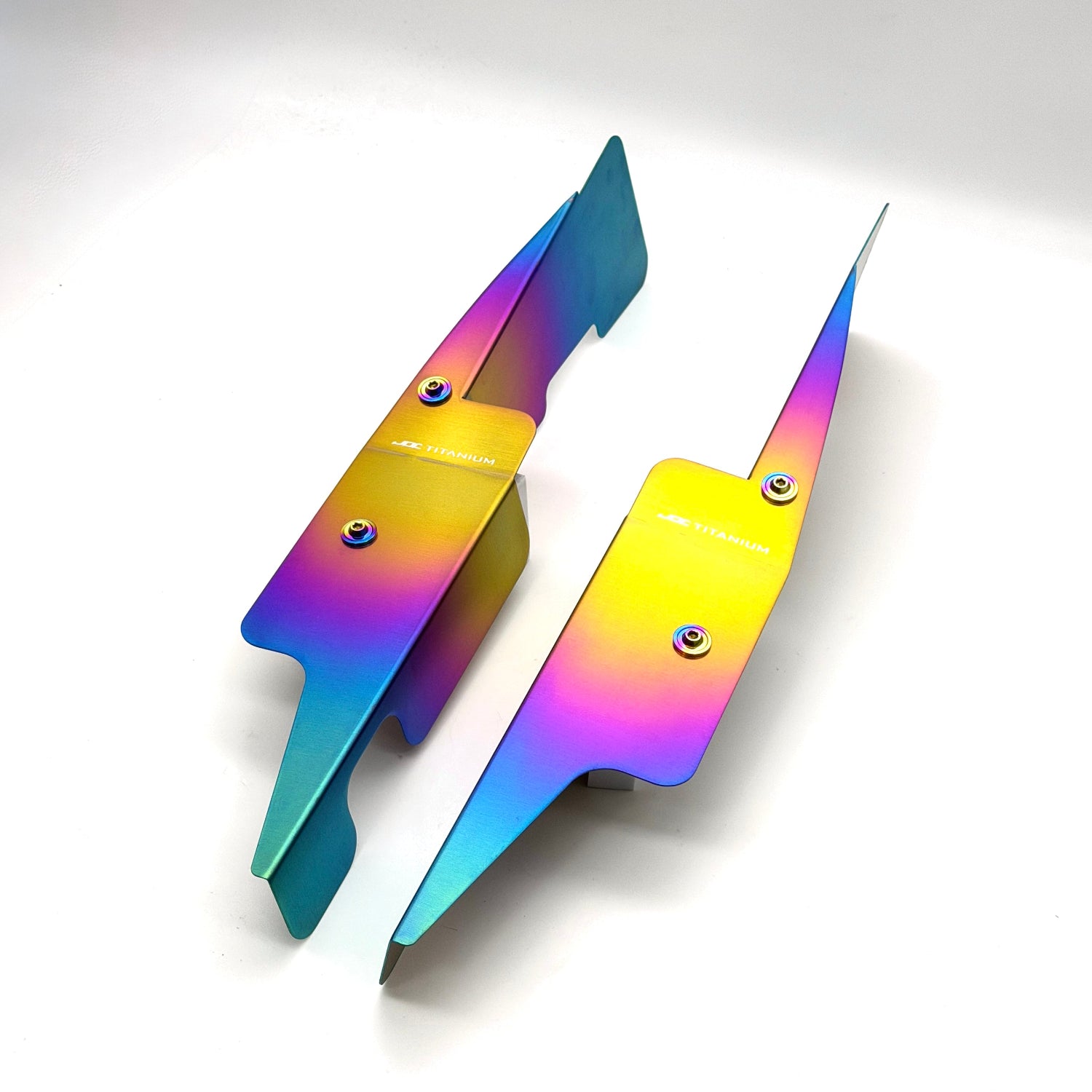 JDC Titanium fender shroud for 2023-2025 Toyota GR Corolla in a Freaktanium gradient finish with matching titanium hardware on a white background