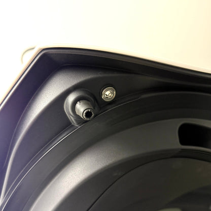Trunk bump stop on a GR Corolla with titanium hardware and washer installed next to it.