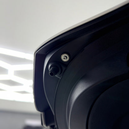Trunk bump stop on a GR Corolla with titanium hardware and washer installed next to it.