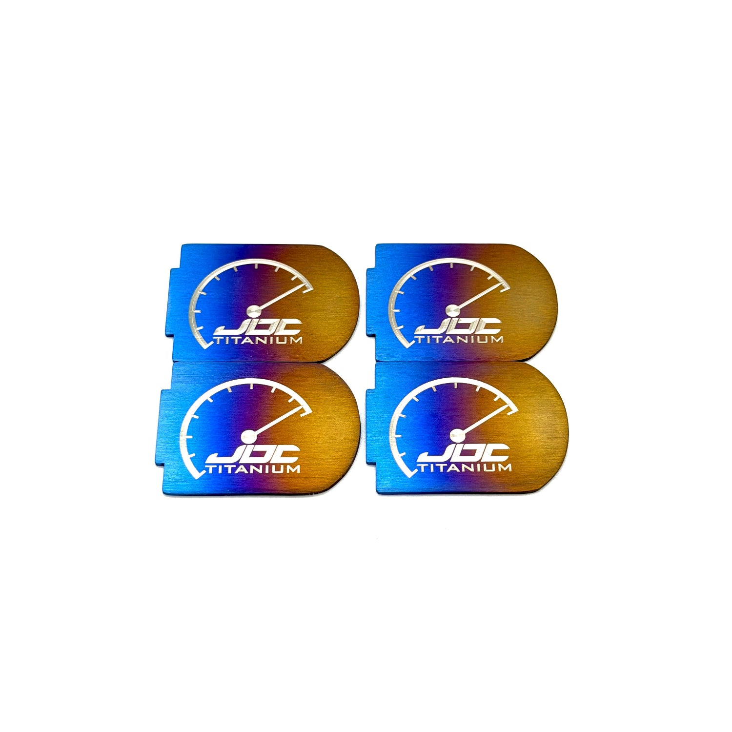 Four JDC Titanium branded coil plaques on a white background