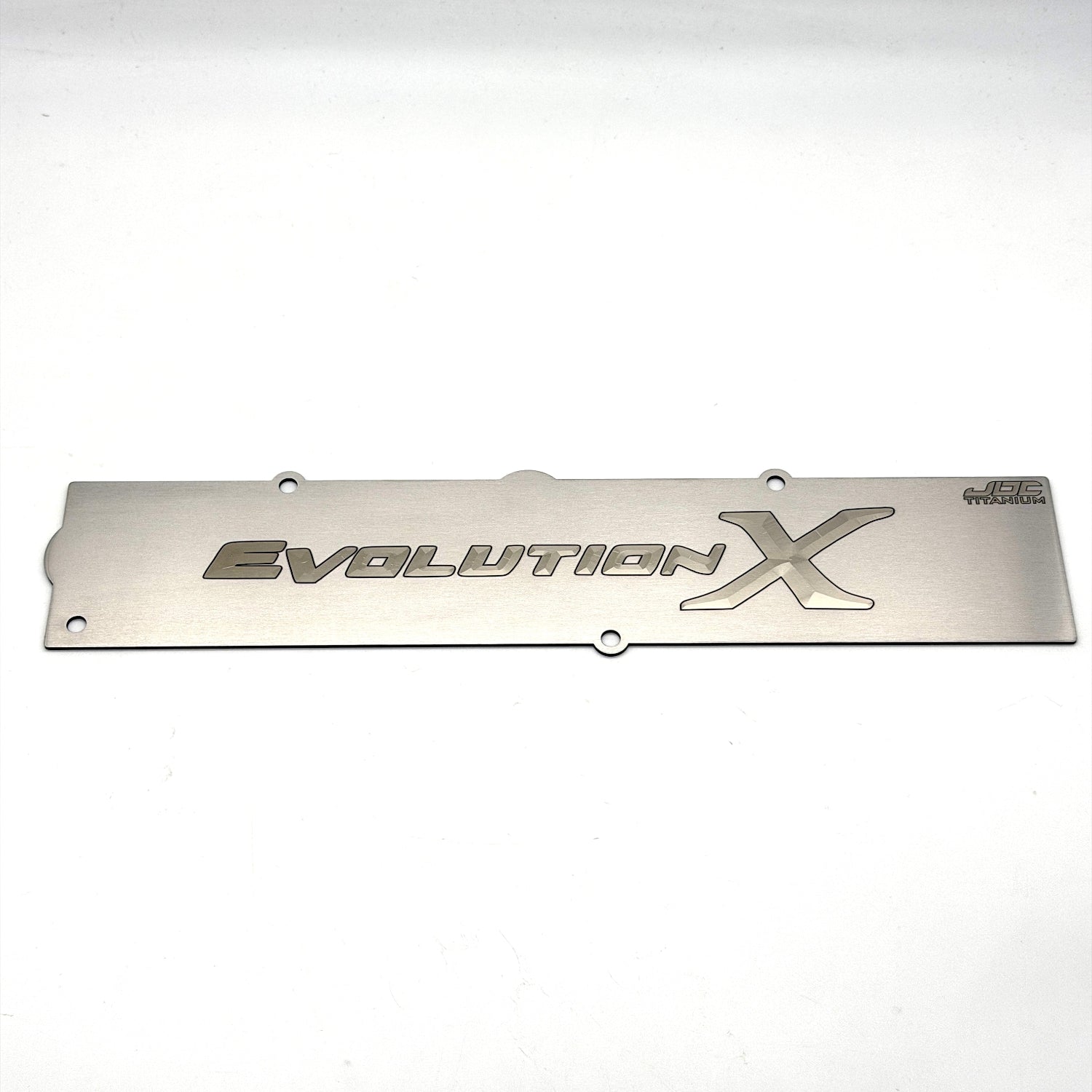 Bare titanium spark plug cover for Evolution X with a bare logo and dark outline.