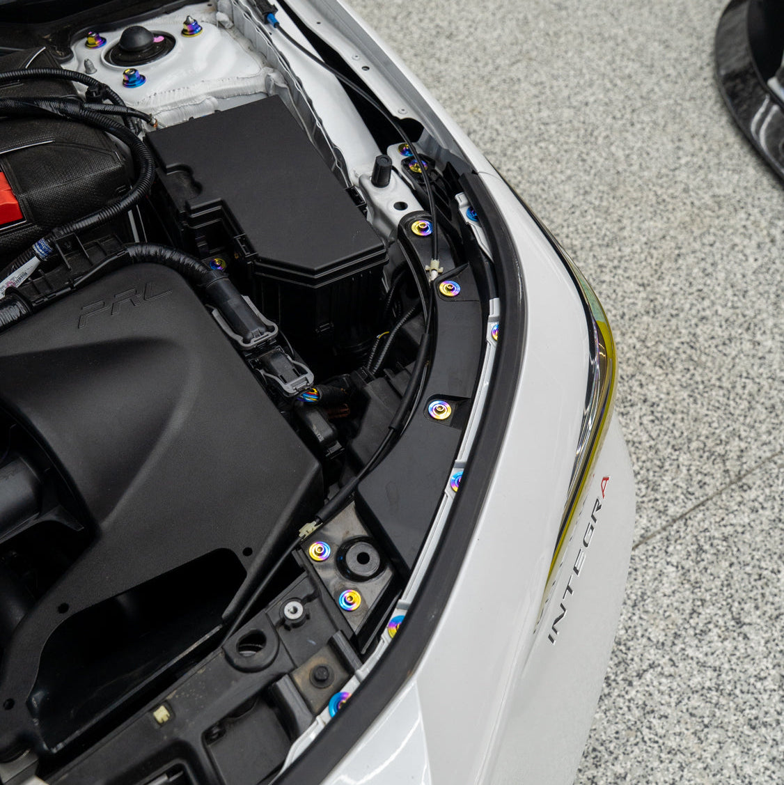 Gradient freaktanium titanium hardware installed on a white Acura Integra A-Spec