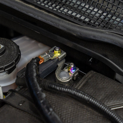 Gradient freaktanium titanium hardware installed on a white Acura Integra A-Spec battery