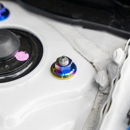 Gradient freaktanium titanium hardware installed on a white Acura Integra A-Spec strut tower