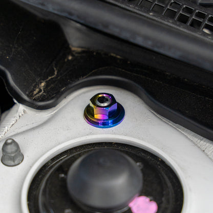 Gradient freaktanium titanium hardware installed on a white Acura Integra A-Spec strut tower