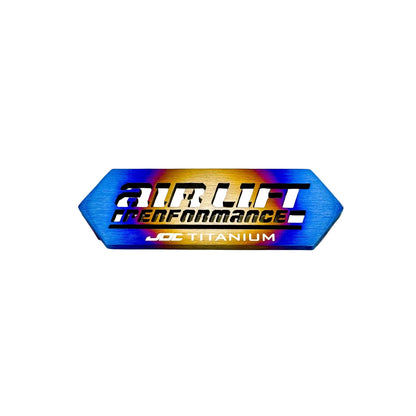 JDC Titanium ALP4 Manifold Badge in a burnt finish with cut-through Design
