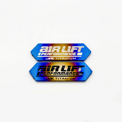 JDC Titanium ALP4 Manifold Badge in a burnt finish with cut-through and laser-etched option Design