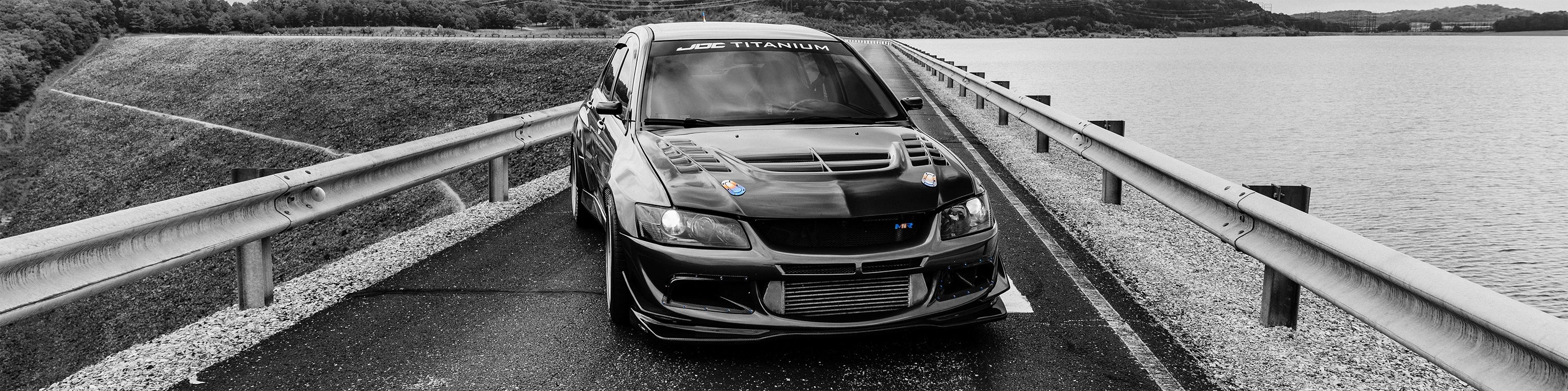 Mitsubishi Evolution on a bridge over water