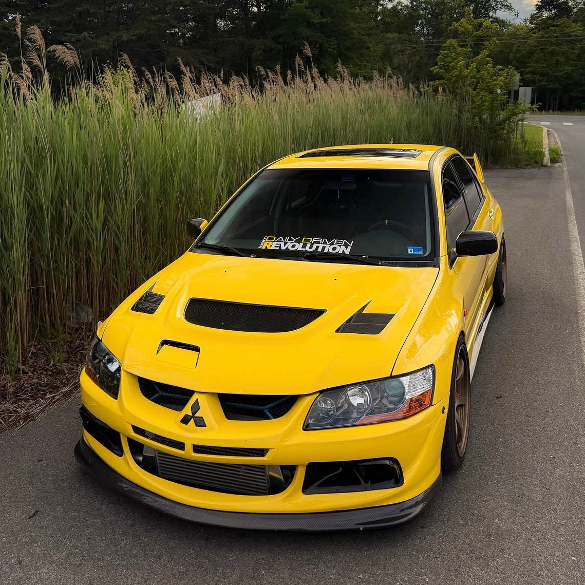 Rexpeed D-style front lip installed on a yellow Evo 8
