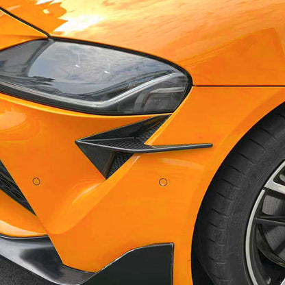 Carbon fiber canards for 2020-2025 Toyota A90 Supra on an orange car.