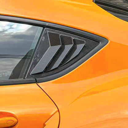 Carbon fiber car window louvers on an orange A90 Supra