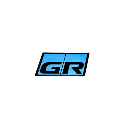 Blue and black GR badge on a white background.
