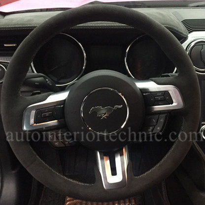Steering wheel with Ford logo in a car interior with AIT steering wheel wrap.