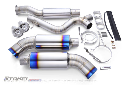 Tomei exhaust system components on a white background